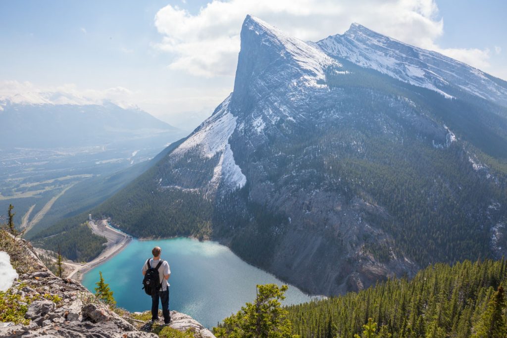guy hiking and looking over a lake