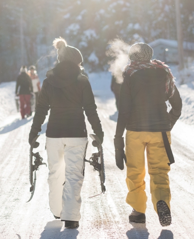 two people walking together and snowshoeing