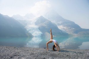 Cam Lee doing yoga by a lake
