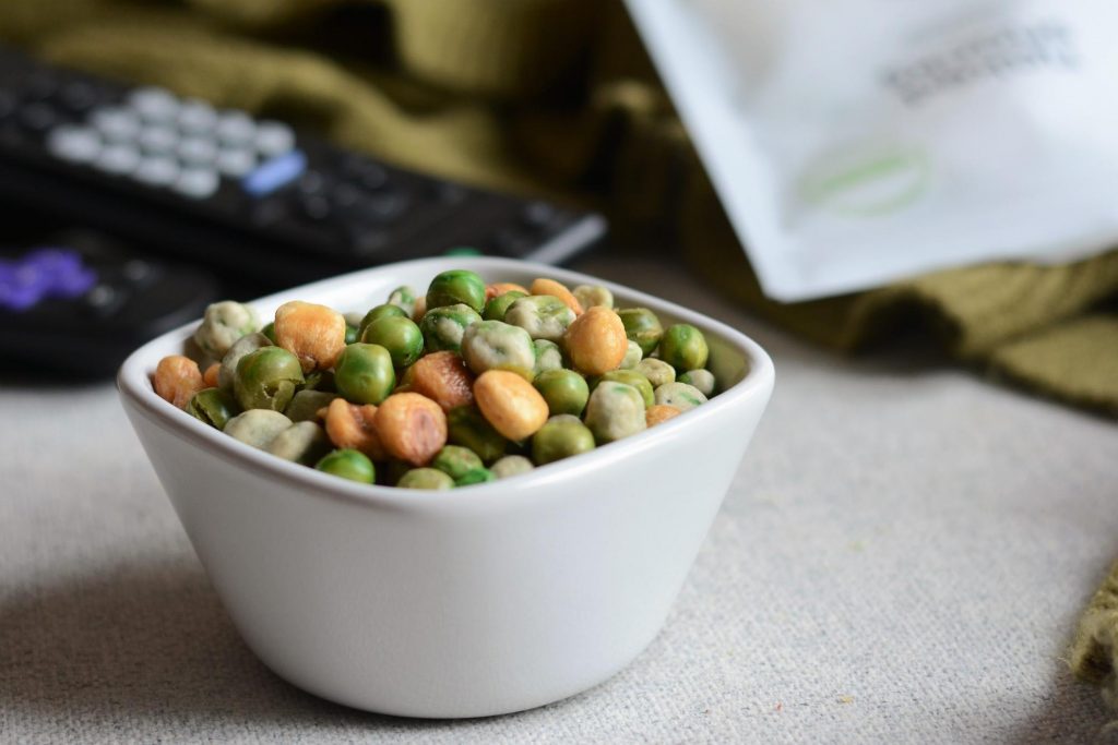 bowl of weekend crunch snack mix, with wasabi peas and corn nuts