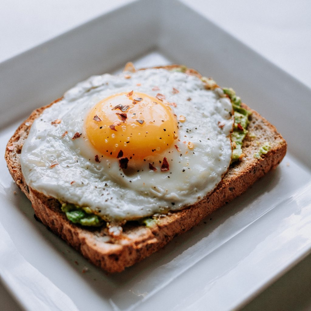 a breakfast made of eggs on avocado and toast