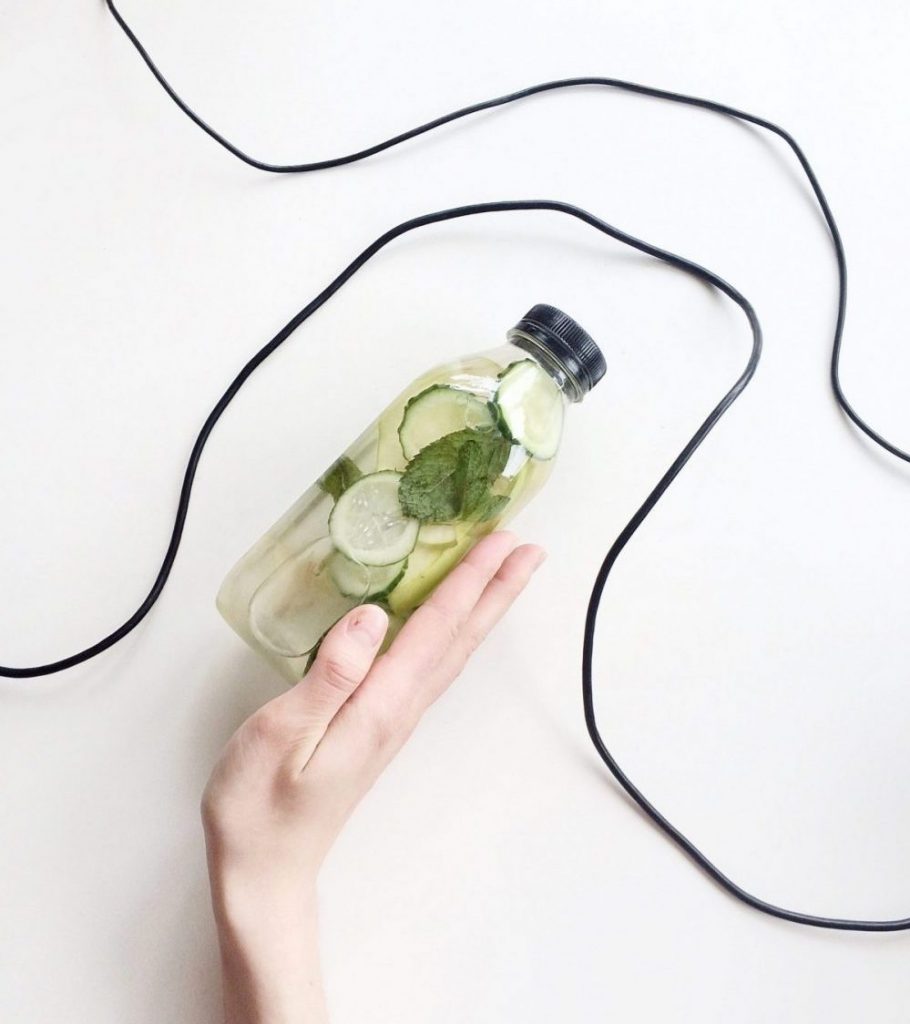 hand holding cucumber water